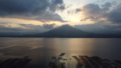 Drone view of Indonesian volcano Batur in the tropical island Bali. Danau Batur, Indonesia. Lake in sunset, touristic hiking place