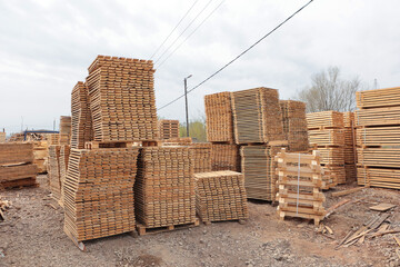Stacks of wooden pallets. Industrial wooden pallets in stock. Concept of cargo transportation and shipping. Eco-friendly products.Pallets made of renewable wood.