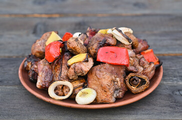 Meat and vegetables made on the grill lie in a plate.