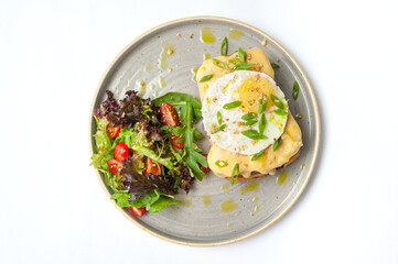 Set of breakfast dishes: croissants, toast, scrambled eggs, salad, bruschetta