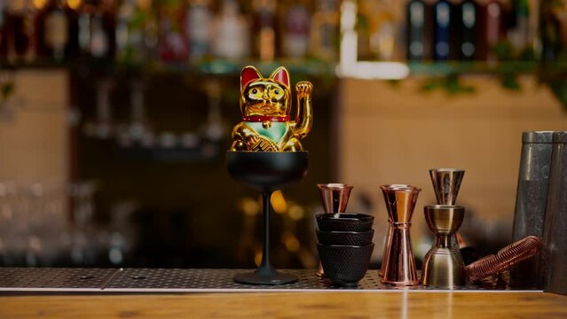figurine of a golden money cat in a cocktail glass a good luck charm