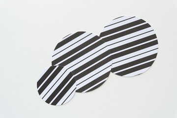 three layered paper circles with lines in black and white on blank paper
