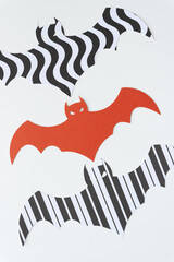 batcraft or Chiroptera Articus (machine-cut paper ding-bats) in orange and black and white paper with pattern on white