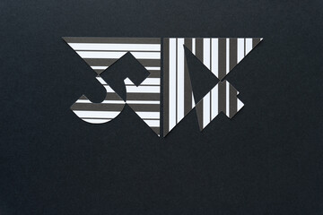 the number 5 and 4 or fifty-four machine-cut from paper with lines and arranged on black paper