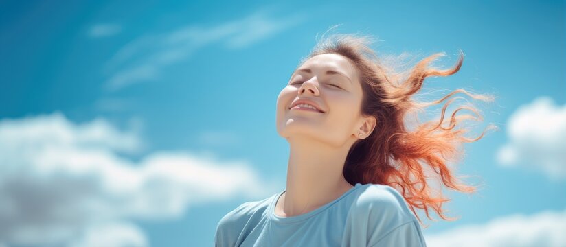 Caucasian woman stretching and relaxing under clear blue sky on bank holiday