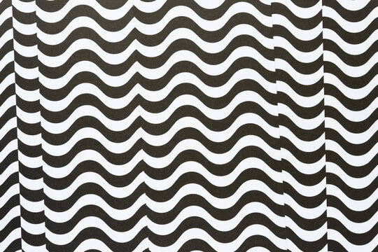 black and white paper with optically challenging wavy lines and slight offset pattern at edges