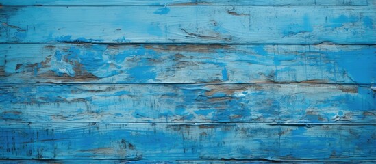 Blue painted wooden boards used as a planked background displaying cracked textures