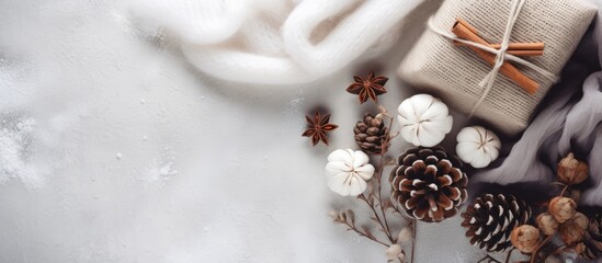 Christmas themed flat lay with winter presents pine cones cinnamon and cotton on a light knitted blanket