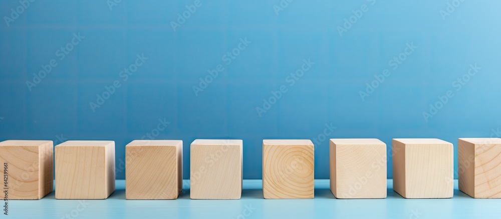 Aufkleber empty wooden blocks on table with blue background space for text or symbols representing growth and 