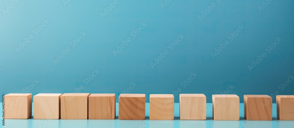 Poster Empty wooden blocks on table with blue background space for text or symbols representing growth and success