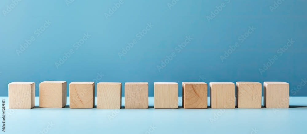 Poster Empty wooden blocks on table with blue background space for text or symbols representing growth and success