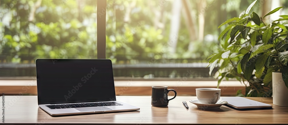 Poster Modern laptop on a table in an office creating a comfortable environment for design