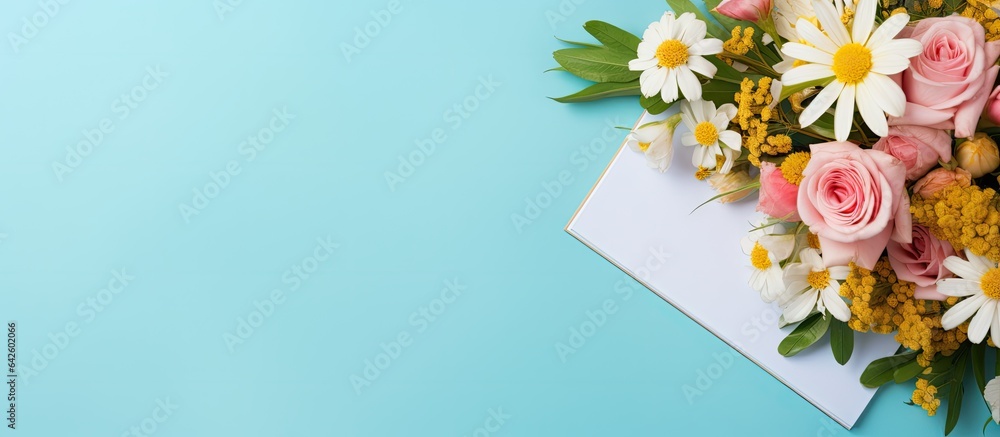 Aufkleber Notebook flowers and computer keyboard on blue background with room for text
