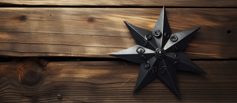 Traditional Japanese throwing star embedded in wooden background