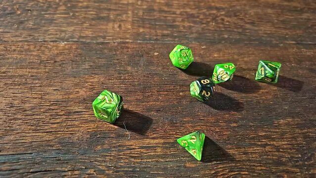 RPG dice, RPG game dice falling in super slow motian over rough surface, selective focus.