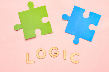 Word LOGIC with puzzle pieces on pink background