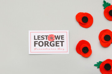 Red poppy flowers with card on grey background. Remembrance Day in Canada
