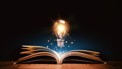 Glowing lightbulb over a book, Inspiring from read concept,  Education knowledge and business...