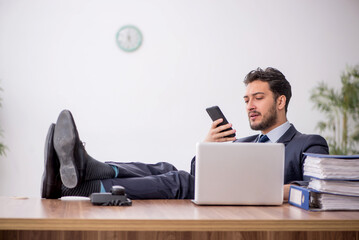 Young male employee working in the office