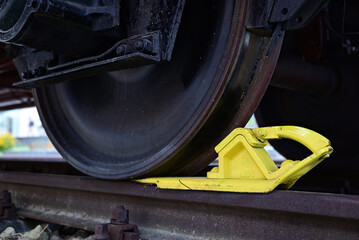 Yellow rail chock on a railcar.