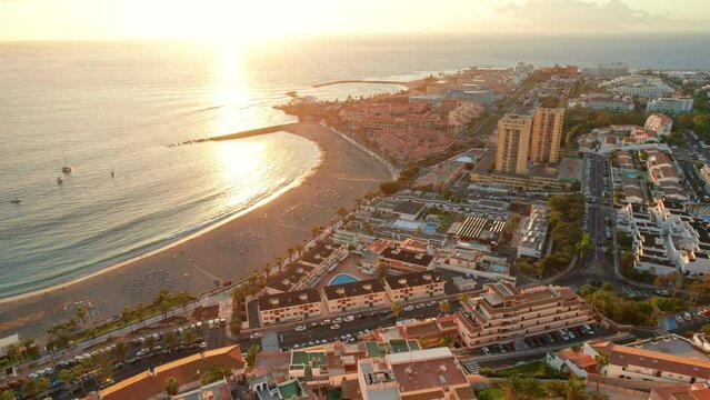 Fuente Playa de Las Vistas beach in Los Cristianos town on Tenerife at sunset