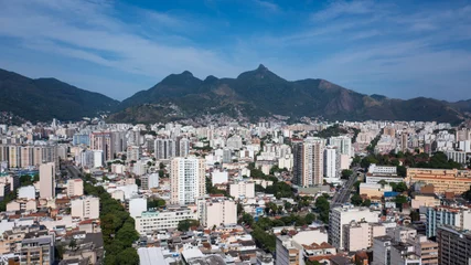 Fotobehang Aerial view of the urban area of the North Zone of Rio de Janeiro and in the background the mountain range that makes up the Tijuca massif and the Tijuca National Park. © Marcio Isensee e Sá