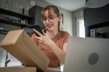 one woman checking box of received package or product at home