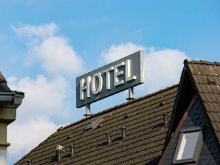 Hotel sign on a rooftop. Big advertisement for the hospitality service. Business in the tourism and travel industry.