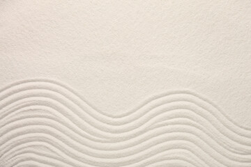Obraz premium White sand with pattern as background, top view. Zen concept