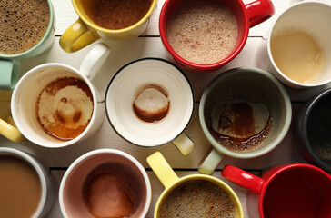 Many different cups with aromatic coffee and dirty ones on white wooden table, flat lay - obrazy, fototapety, plakaty