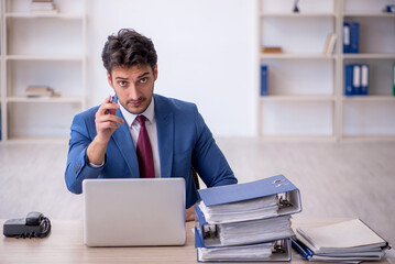 Young male employee working in the office
