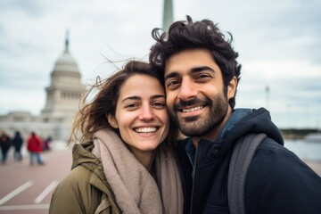 Couple in their 30s smiling in front of the Statue of Liberty in New York USA