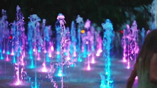 colorful music fountain with color light and water illumination, slow motion