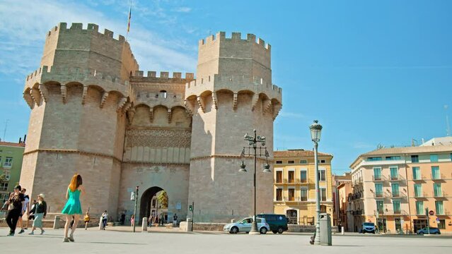 Hyperlapse of tourists walking by Torres de Serranos old city walls of Valencia. Timelapse of People exploring historical twin towers Portal dels Serrans 