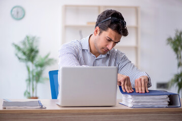 Young male employee working in the office