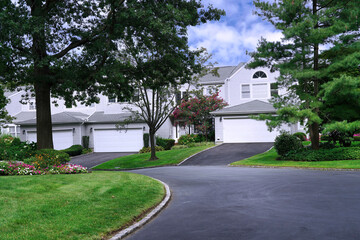 Suburban residential street, houses with two-car garage.