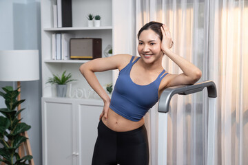 Fototapeta na wymiar Asian woman in sportswear portrait, smiling and posing cheerful gesture. Home workout training or exercise fitness lifestyle. Attractive girl engage in her pursuit of healthy lifestyle. Vigorous