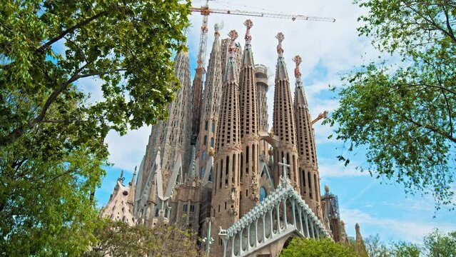 Beautiful view of La Sagrada Familia Basilica in Barcelona Spain in Europe. The most famous tourist attraction and landmark in Catalonia with museum and city views on a sunny day with a blue sky.