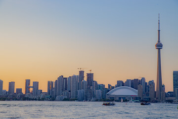 Sunset view of Toronto and water taxi in lake Ontario