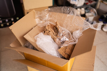 Cardboard box with bubble wrap and kraft paper for packaging