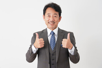 グッドサインする中年のビジネスマン　白背景