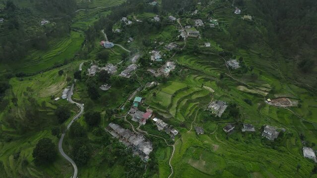 Aerial shot of landscape of uttarakhand with small village on the top of the mountain. 