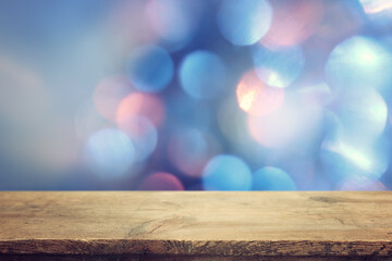 Empty table in front of christmas glitter bokeh background with lights. Ready for product display...