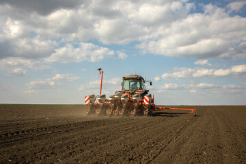 Farmer in tractor sowing crops