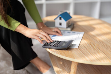 Woman renter using calculator for business financial accounting calculate money bank house loan...