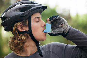 Asthma, cyclist and man with medical emergency and breathing medicine in a forest for exercise or fitness. Lung, training and young person with support for health, wellness and relief inhaler - obrazy, fototapety, plakaty