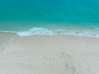 Beach Wave water in the Tropical summer beach with  sandy beach background