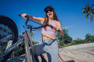 Happy young woman enjoy BMX riding at the skatepark