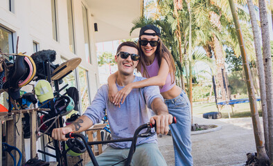 Young happy couple enjoy BMX riding at the skatepark