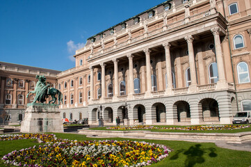 Obraz premium National Gallery and Castle in Budapest, Hungary in autumn with horse statue and flowers.
